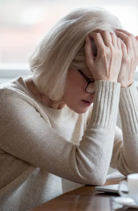 Woman with head in her hands