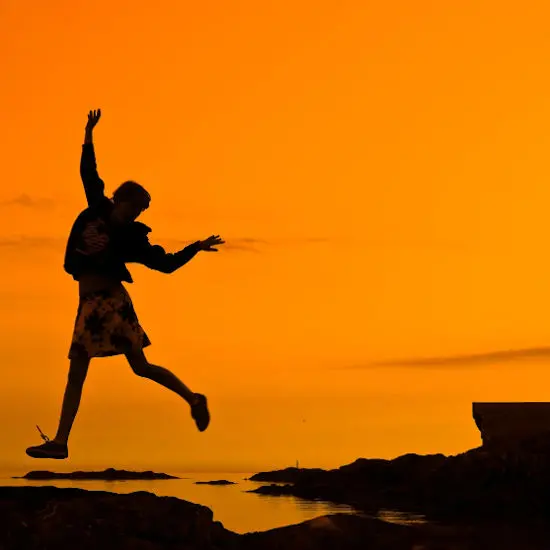 person silhouette against orange background